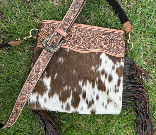 large cowhide bag with tooled shoulder strap ￼